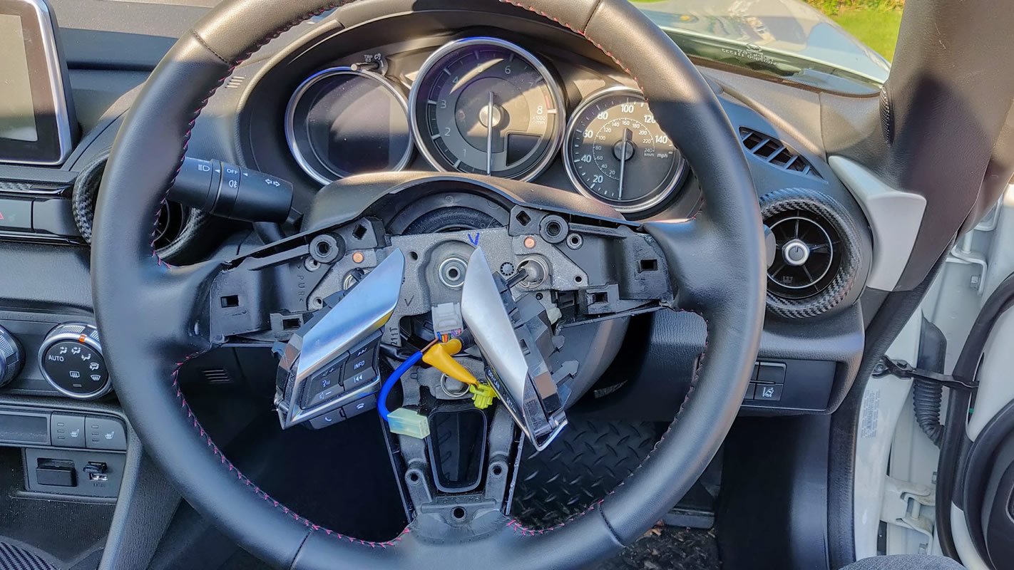 The steering wheel without its airbag or circular chrome trim